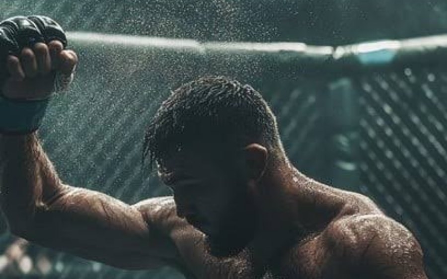 An MMA fighter mid-fight inside the cage
